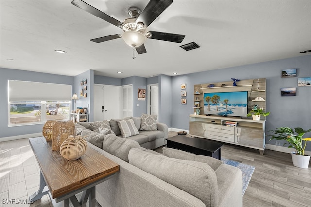 living room featuring hardwood / wood-style flooring and ceiling fan