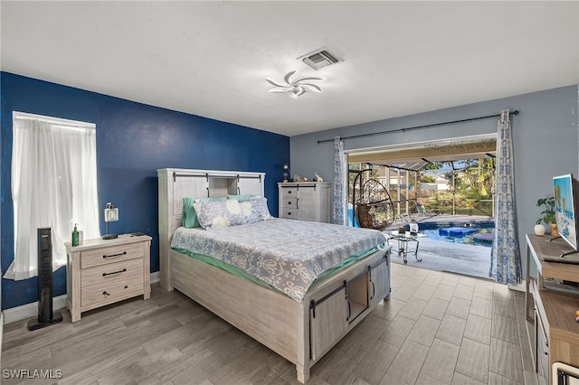 bedroom featuring access to exterior and light hardwood / wood-style floors