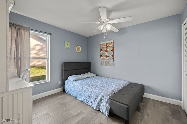 bedroom with light hardwood / wood-style flooring and ceiling fan