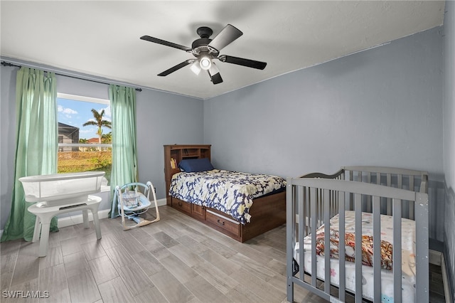 bedroom with ceiling fan and light hardwood / wood-style flooring