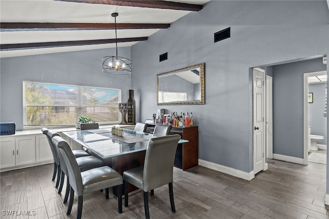 dining room featuring light hardwood / wood-style floors, lofted ceiling with beams, and a chandelier