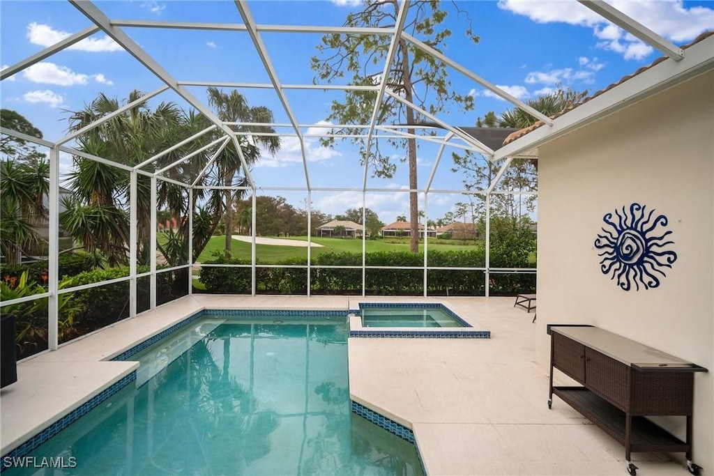 view of pool featuring a lanai, a patio, and an in ground hot tub