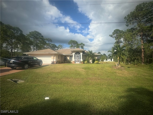 view of front of house featuring a garage and a front yard