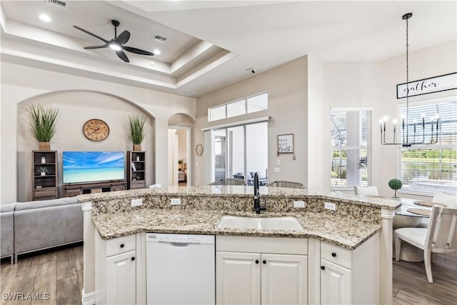 7821 Ashton Rd, Naples, FL 34113 - kitchen featuring dishwasher, open floor plan, light wood finished floors, ceiling fan, and an island with sink