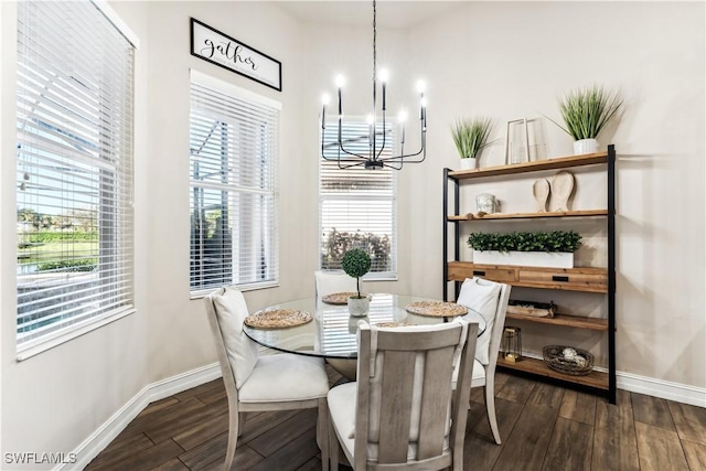 dining area featuring dark hardwood / wood-style flooring and a notable chandelier