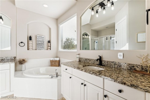 bathroom featuring vanity and separate shower and tub