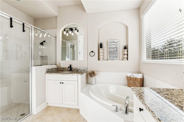 7821 Ashton Rd, Naples, FL 34113 - full bath with vanity, a shower stall, a garden tub, and tile patterned flooring