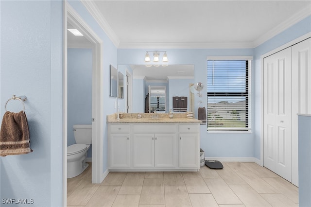 bathroom with toilet, vanity, and ornamental molding