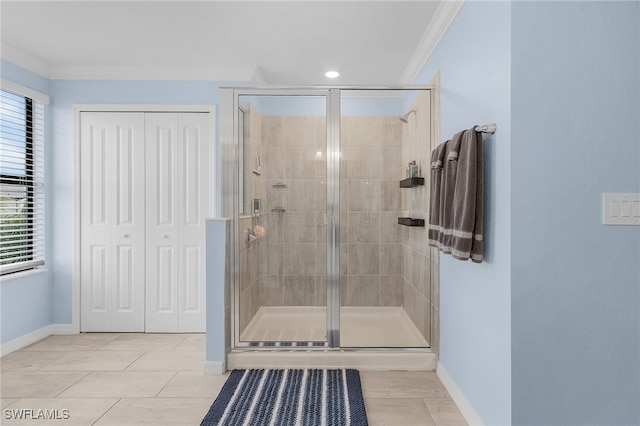 bathroom featuring tile patterned flooring, a shower with door, and ornamental molding