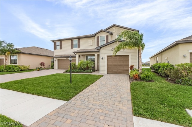 view of front of house with a garage and a front yard