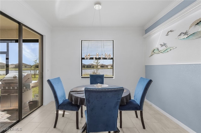 tiled dining room featuring ornamental molding