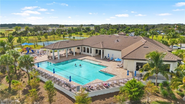 view of pool featuring a water view and a patio area