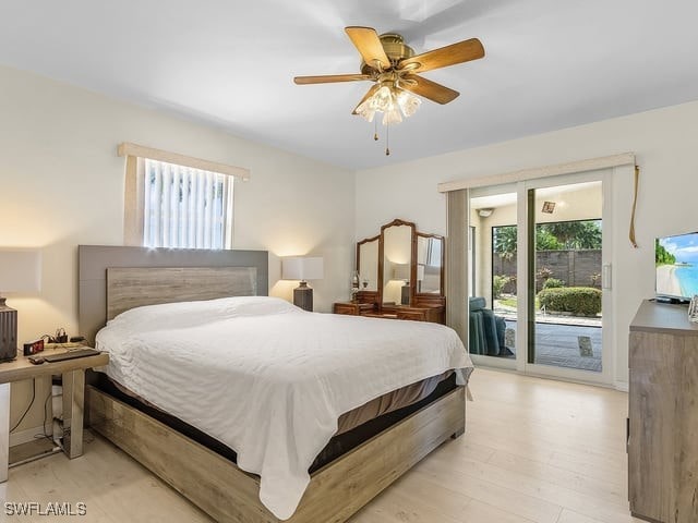 bedroom featuring light hardwood / wood-style floors, access to outside, and ceiling fan