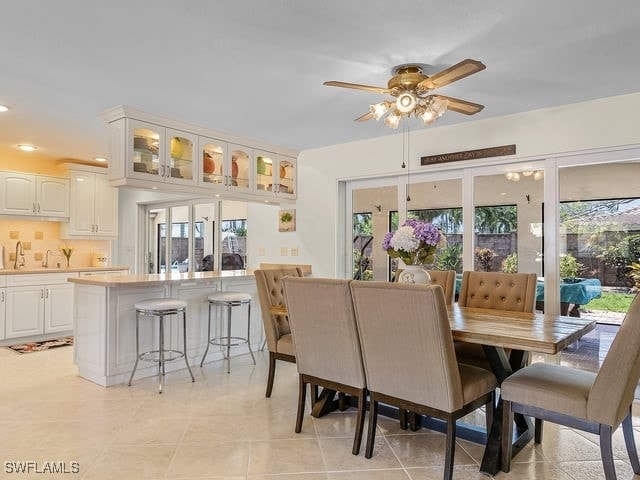 dining area featuring a wealth of natural light, light tile patterned floors, and ceiling fan