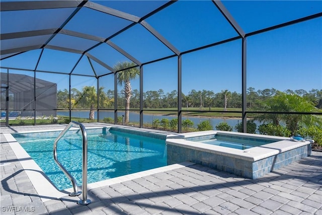 view of pool featuring an in ground hot tub, a patio area, glass enclosure, and a water view