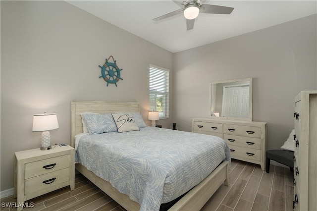 bedroom featuring a ceiling fan and wood tiled floor