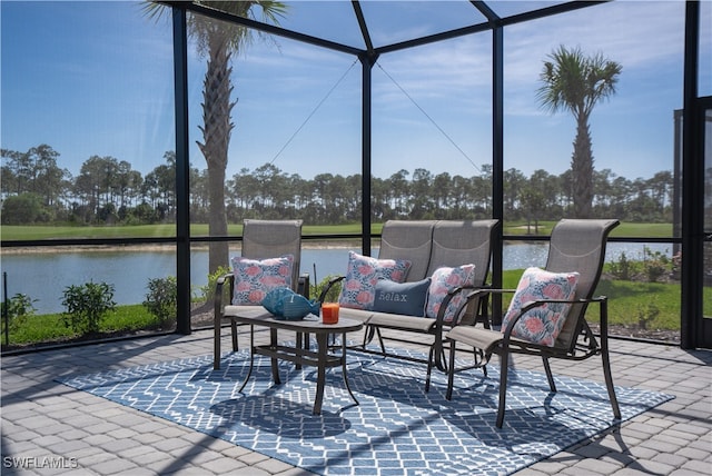 sunroom featuring a water view