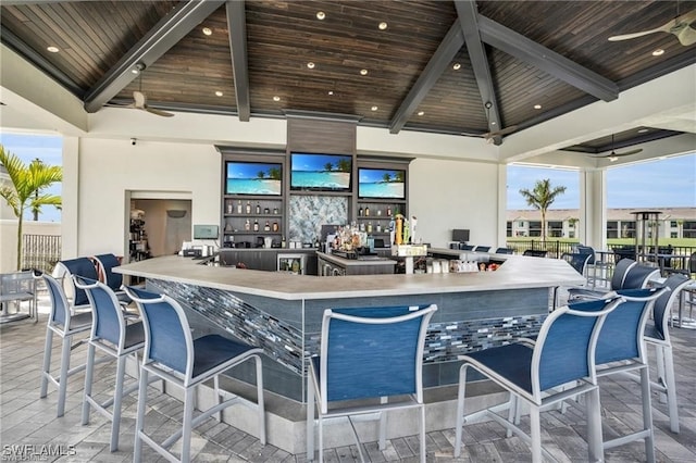 exterior space with outdoor wet bar and a ceiling fan