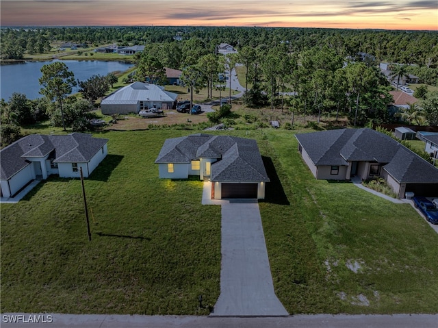 aerial view at dusk with a water view