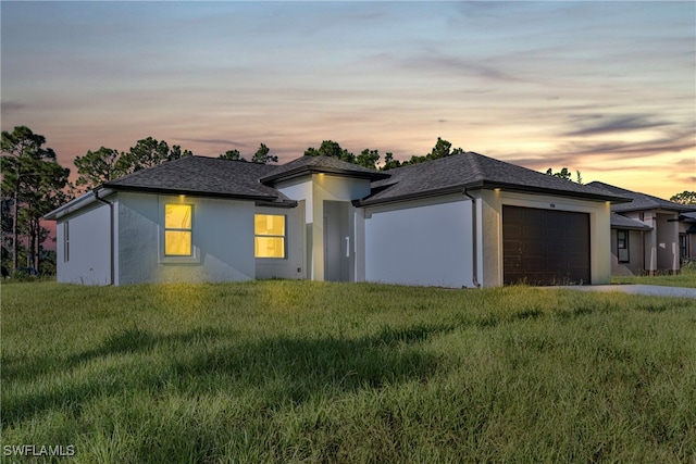 prairie-style house with a lawn and a garage