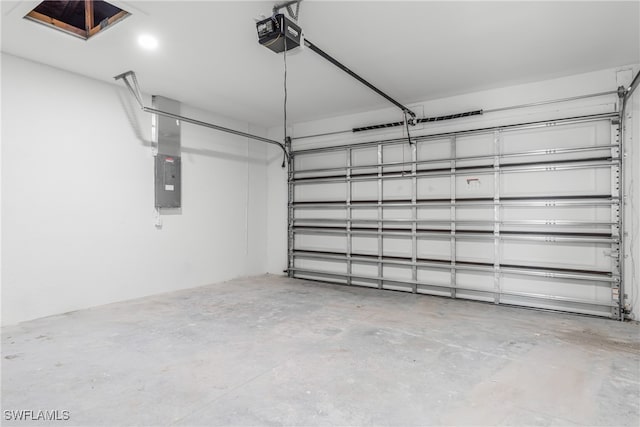 garage with a garage door opener and electric panel