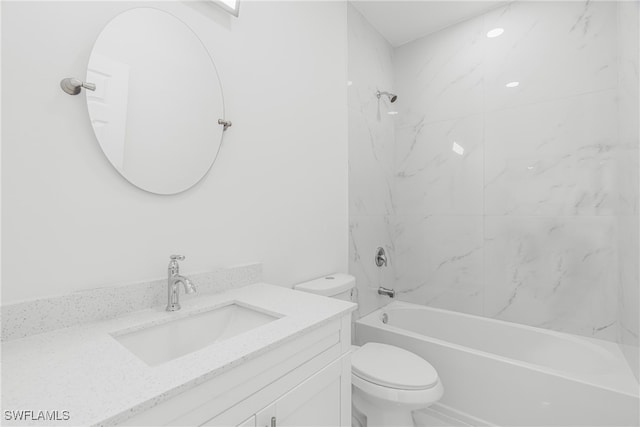 full bathroom featuring vanity, tiled shower / bath combo, and toilet