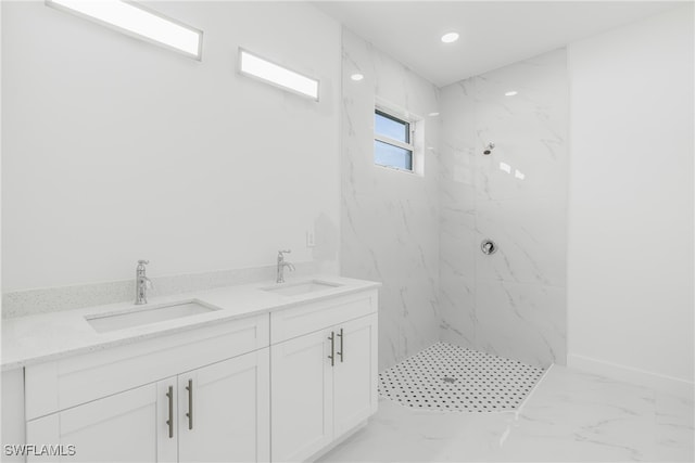 bathroom with vanity and tiled shower