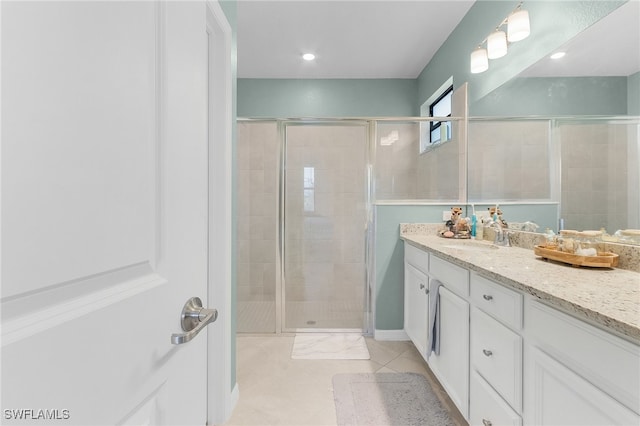 bathroom with walk in shower, tile patterned flooring, and vanity