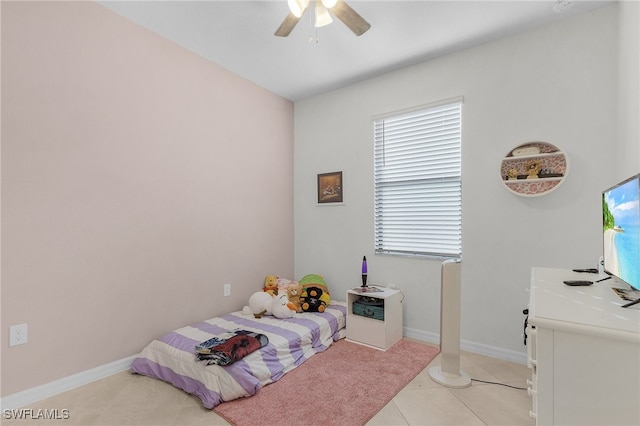 tiled bedroom featuring ceiling fan