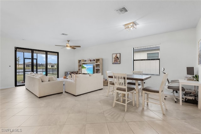 tiled living room with ceiling fan