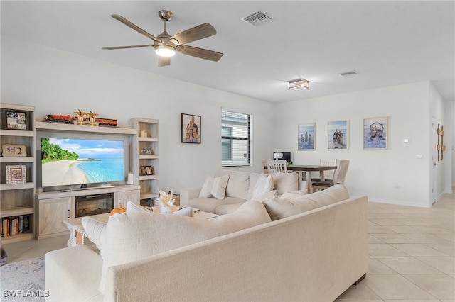 tiled living room with ceiling fan