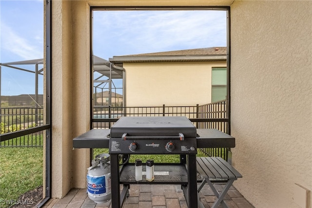 exterior space featuring a patio area, a lanai, and a grill