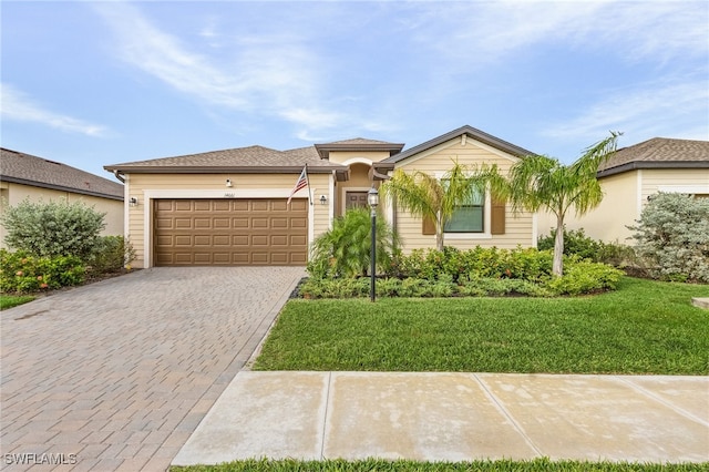 view of front of home featuring a garage and a front yard