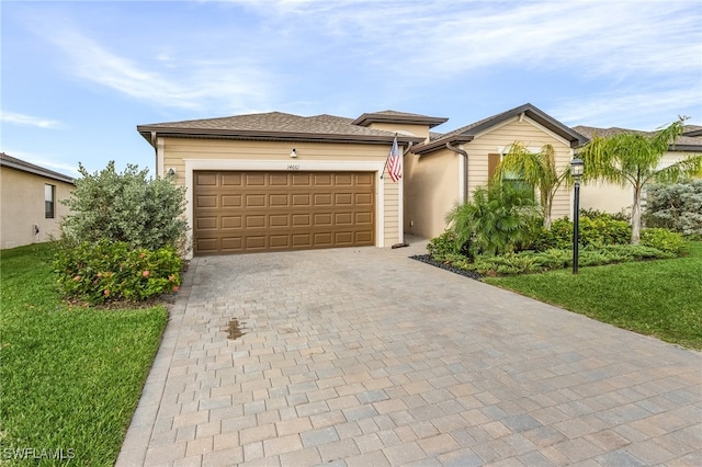 view of front of property with a garage and a front lawn