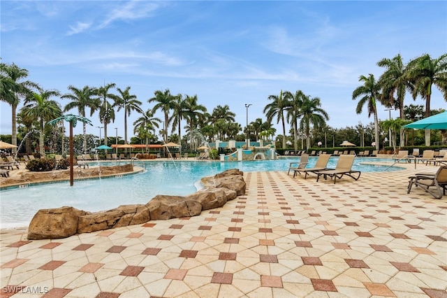 view of pool featuring pool water feature and a patio area