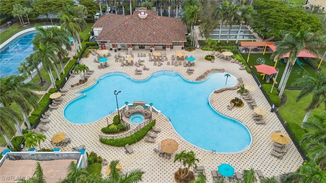 view of pool featuring a hot tub and a patio area