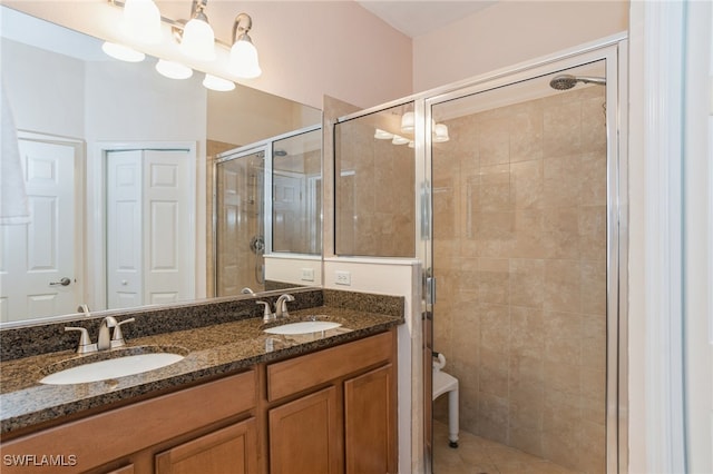 bathroom featuring tile patterned flooring, an enclosed shower, and vanity