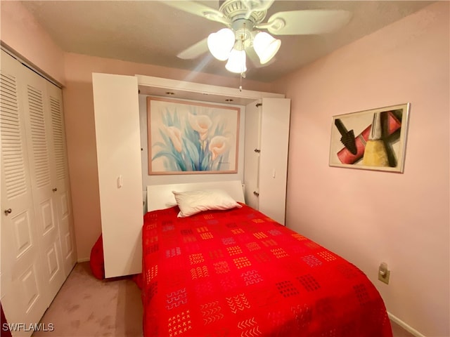 carpeted bedroom with a closet and ceiling fan