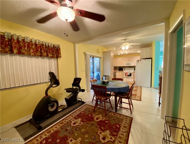 dining room with ceiling fan, a textured ceiling, and light tile patterned flooring