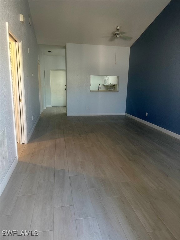 unfurnished living room with light wood-type flooring and ceiling fan