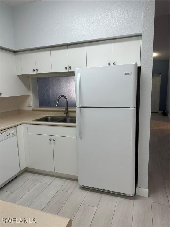8358 Bernwood Cove Loop Unit 706, Fort Myers, FL 33966 - kitchen featuring white appliances, a sink, white cabinetry, and wood finish floors