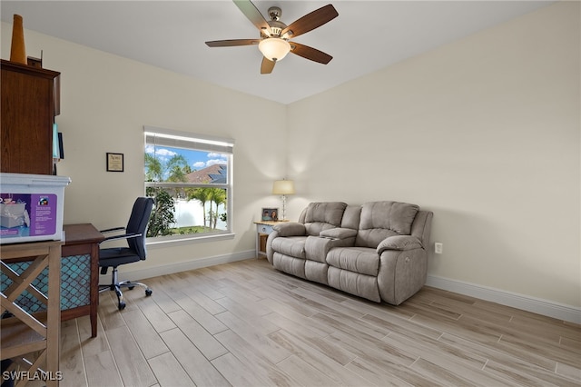 office featuring wood finish floors, a ceiling fan, and baseboards