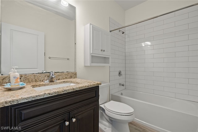 bathroom with tub / shower combination, vanity, toilet, and wood finished floors