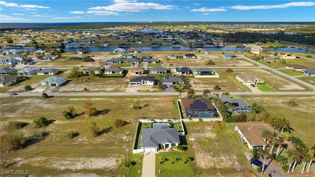 birds eye view of property featuring a residential view and a water view