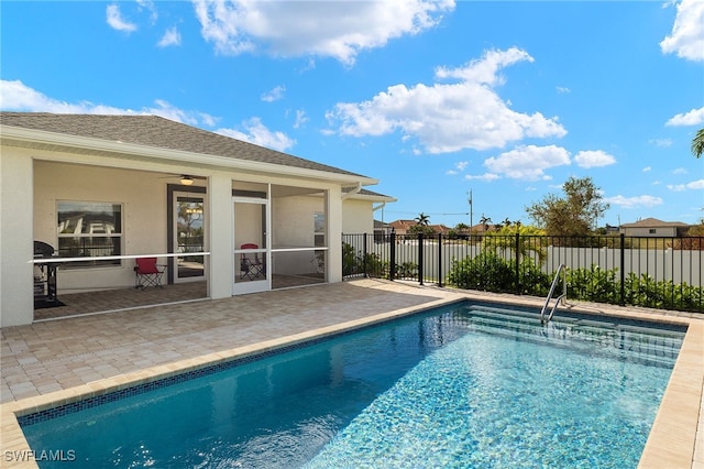 view of swimming pool featuring a fenced in pool, a sunroom, a patio area, fence, and ceiling fan