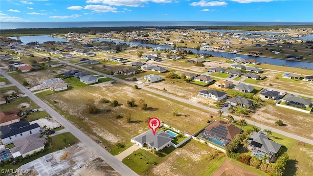 drone / aerial view featuring a water view and a residential view