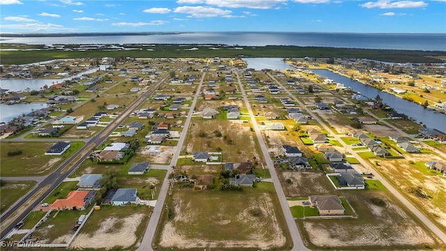 birds eye view of property with a water view and a residential view