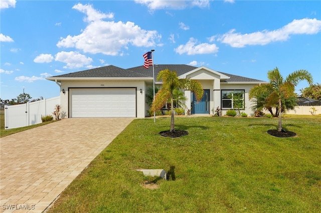 ranch-style house featuring an attached garage, fence, decorative driveway, a front yard, and stucco siding