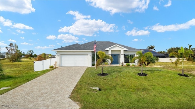 ranch-style home with a garage, decorative driveway, a front yard, and fence