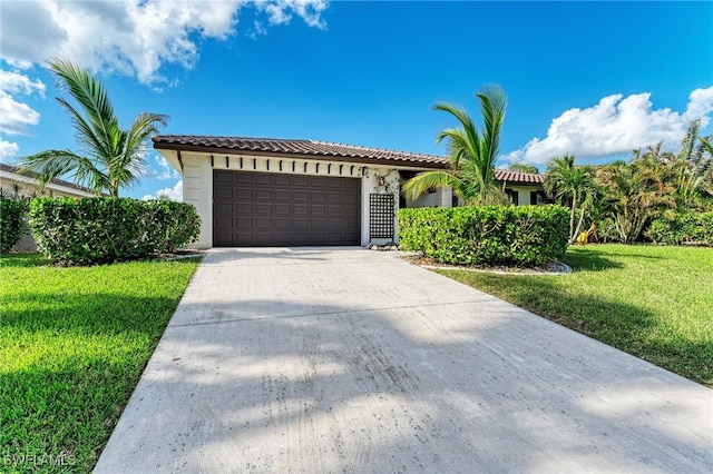 mediterranean / spanish-style home with a garage and a front lawn